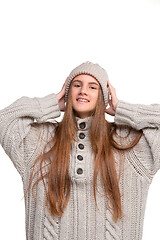 Image showing portrait of cute little kid in stylish knitted sweater looking at camera and smiling