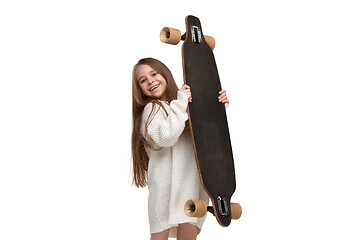 Image showing portrait of an adorable young girl riding a skateboard isolated against white background