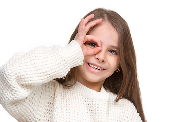 Image showing portrait of cute little kid in stylish knitted sweater looking at camera and smiling