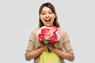 Image showing happy asian woman with bunch of flowers