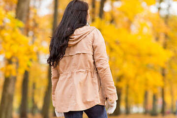 Image showing young woman walking in autumn park