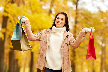 Image showing woman with shopping bags in autumn park