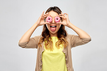 Image showing asian woman with eyes of donuts showing tongue