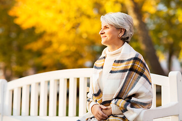 Image showing portrait of happy senior woman at autumn park