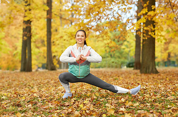 Image showing young woman doing sports at autumn park