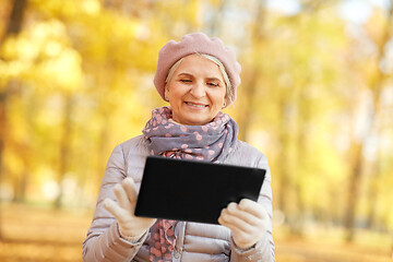 Image showing senior woman with tablet pc at summer park