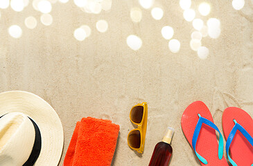 Image showing straw hat, flip flops and sunglasses on beach sand