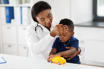 Image showing doctor with measuring baby\'s temperature at clinic