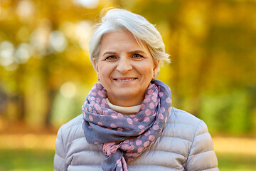 Image showing portrait of happy senior woman at autumn park