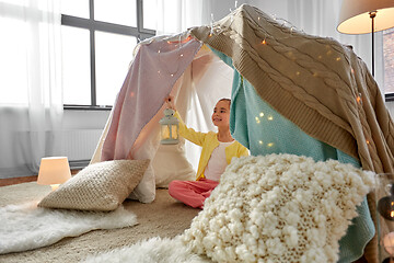 Image showing little girl with lantern in kids tent at home