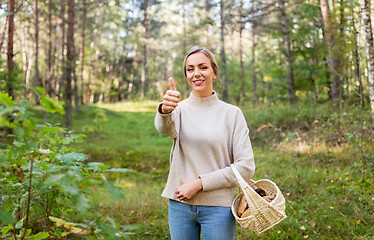 Image showing woman with basket of mushrooms in forest