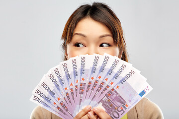 Image showing asian woman with hundreds of euro money banknotes