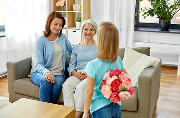 Image showing grandmother, mother and daughter with flowers