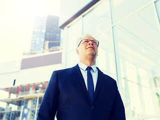 Image showing senior businessman on city street