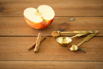 Image showing half apple and knife on wooden cutting board