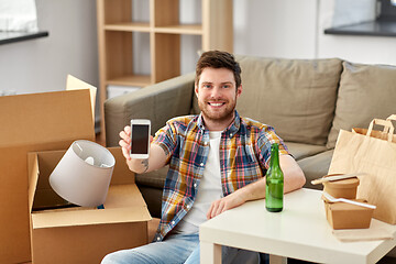 Image showing man with smartphone and takeaway food moving