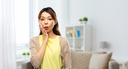 Image showing surprised asian woman at home