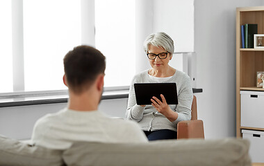 Image showing senior psychologist with tablet pc and patient