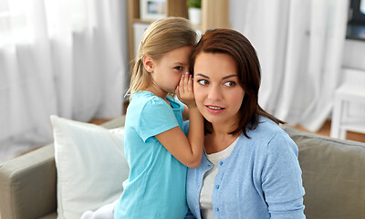 Image showing daughter whispering secret to mother at home