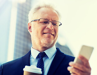 Image showing businessman with smartphone and coffee in city