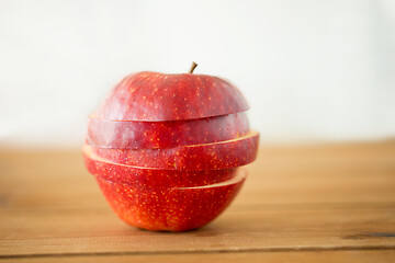 Image showing sliced red apple on wooden table