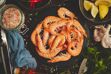 Image showing Raw fresh prawns with various ingredients such as lemon fresh herbs, garlic, chilli pepper