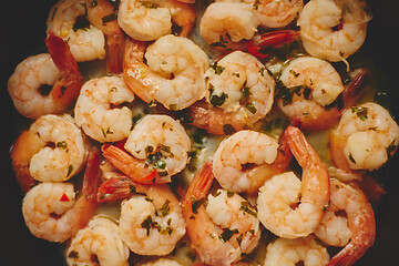 Image showing Baby shrimps with parsley and garlic are cooked in a pan, top view, flat lay, close-up