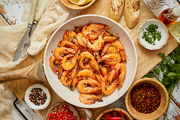 Image showing Roasted Prawns on frying pan served on white wooden cutting board