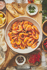 Image showing Traditional fried tiger prawn with garlic bread as top view served in a white frying pan