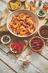 Image showing Traditional fried tiger prawn with garlic bread as top view served in a white frying pan