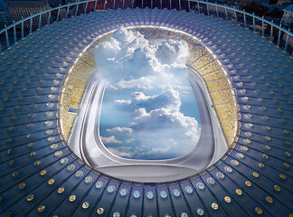 Image showing View of stadium structure with porthole and clouds.