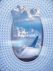 Image showing Airplane window with picture of sky cloudy.