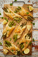 Image showing Grilled green asparagus and cheese puff pastry folded as envelope and topped with black sesame