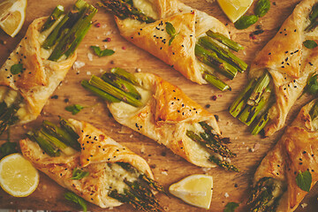 Image showing Grilled green asparagus and cheese puff pastry folded as envelope and topped with black sesame