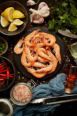 Image showing Fresh and raw big shrimps ready to be prepared. With various ingredients on side