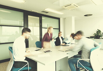 Image showing business people group entering meeting room, motion blur