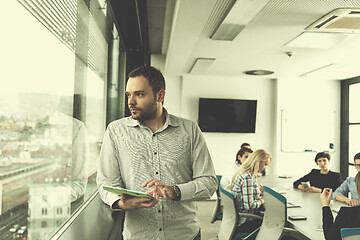 Image showing Businessman Using Tablet In Office Building by window