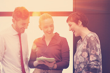 Image showing young business people group working on tablet computer with sunr