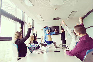 Image showing boss dresed as bear having fun with business people in trendy of