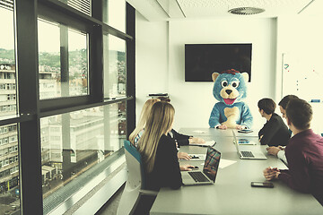 Image showing boss dresed as bear having fun with business people in trendy of