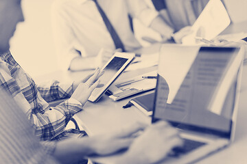 Image showing close up of business man hands typing on laptop with team on mee