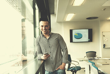 Image showing young business man using smart phone at office