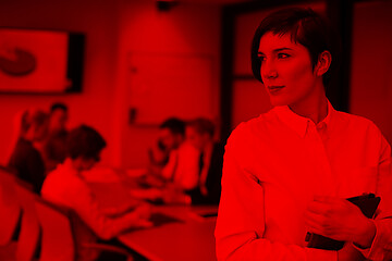 Image showing hispanic businesswoman with tablet at meeting room