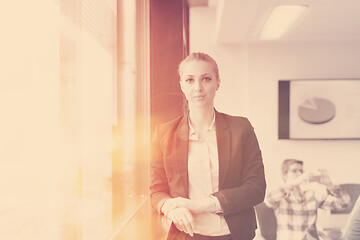 Image showing portrait of young business woman at office with team on meeting 