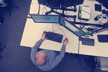 Image showing young programmer writing programming code top view