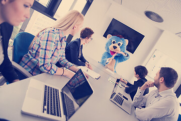 Image showing boss dresed as bear having fun with business people in trendy of