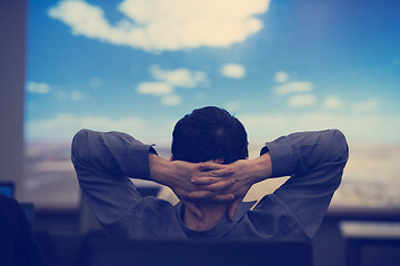 Image showing young man dreaming clouds on presentation