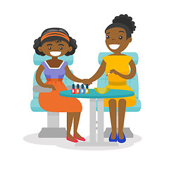 Image showing African woman getting manicure at beauty salon.
