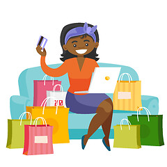 Image showing African woman using laptop for online shopping.