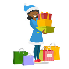 Image showing Young woman in santa hat buying christmas gifts.